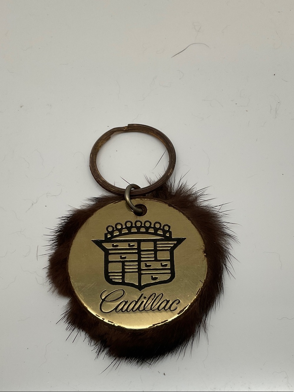 Cadillac Brown Fur Keychain with Gold Emblem and Logo